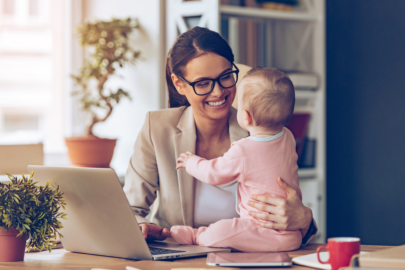 mother working at home with baby